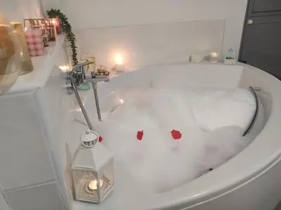 a bath tub with two red hearts in it at Encanto de Oscos in San Martín de Oscos