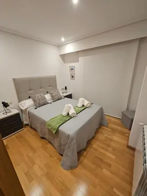 a bedroom with a large bed with two towels on it at Natalia in Allariz
