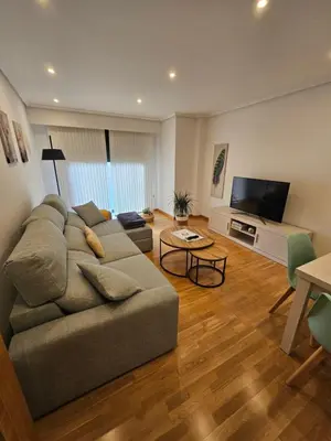 a living room with a couch and a flat screen tv at Natalia in Allariz