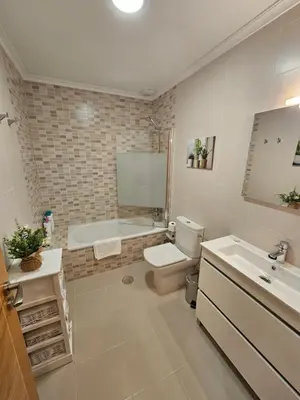 a bathroom with a toilet and a tub and a sink at Natalia in Allariz