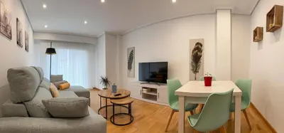 a living room with a couch and a table at Natalia in Allariz