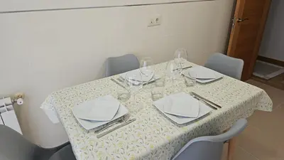 a table with plates and wine glasses on it at Natalia in Allariz