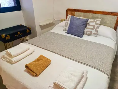a bed with towels and pillows on top of it at A Casiña do Anselmiño in Celanova