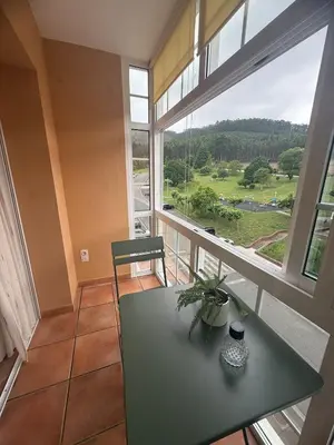 a room with a table and a large window at Apartmento en Xove in Jove