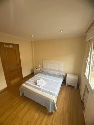 a bedroom with a bed and a wooden floor at Apartmento en Xove in Jove