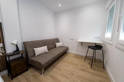 a living room with a couch and a table at Nido PADRON in Padrón