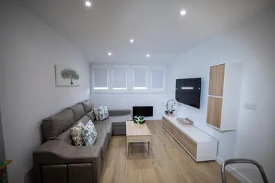 a living room with a couch and a table at Nido PADRON in Padrón