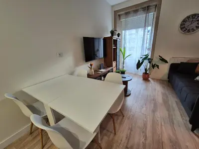 a white table and chairs in a living room at Grândola in Ourense