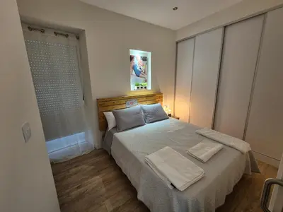 a bedroom with a bed with two towels on it at Grândola in Ourense