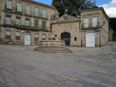 a large stone building with a fountain in front of it at Grândola in Ourense