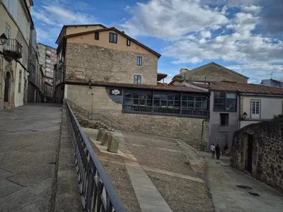 an empty street in a city with a building at Grândola in Ourense