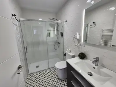 a bathroom with a shower and a toilet and a sink at Grândola in Ourense