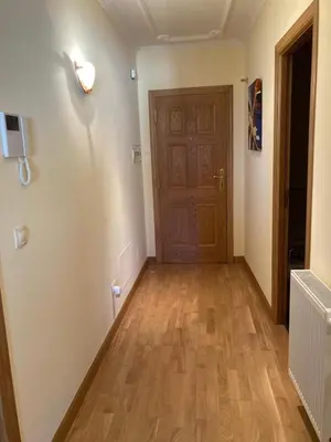 a hallway with a door and a wooden floor at El mirador del mar in Foz