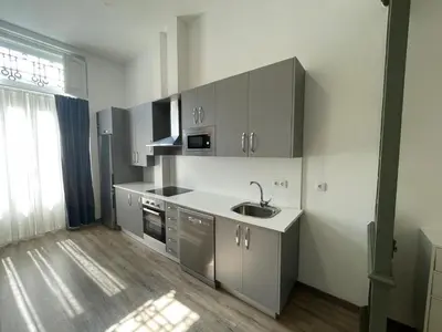 a kitchen with gray cabinets and a sink at Apartamento Paseo Malecón Planta 1 in Monforte de Lemos