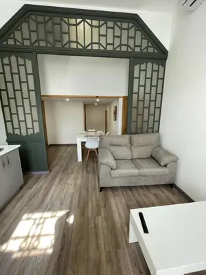 a living room with a couch and a table at Apartamento Paseo Malecón Planta 1 in Monforte de Lemos