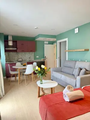 a living room with a couch and a table at Luxury Singular Blue in Santiago de Compostela