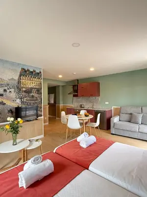 a room with two beds and a living room and a kitchen at Luxury Singular Blue in Santiago de Compostela