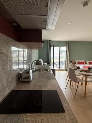 a kitchen and living room with a table and chairs at Luxury Singular Blue in Santiago de Compostela