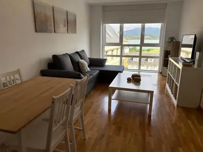 a living room with a couch and a table at Piso Rente o Mar in Foz