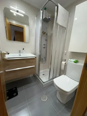 a bathroom with a shower and a toilet and a sink at Piso Rente o Mar in Foz