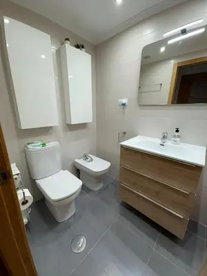 a bathroom with a toilet and a sink at Piso Rente o Mar in Foz