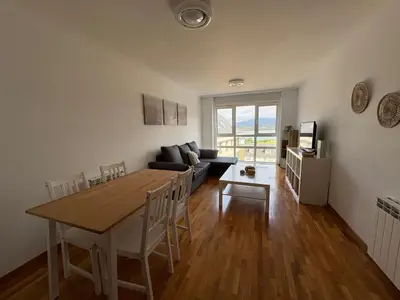 a living room with a table and a couch at Piso Rente o Mar in Foz