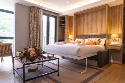 a bedroom with a large bed and a table at Loureira in Pincelo