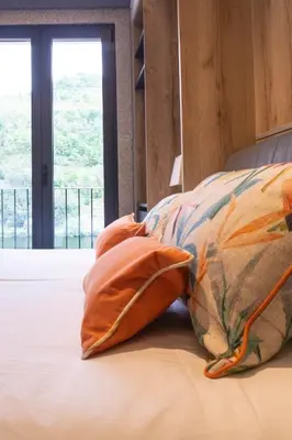 a bed with two pillows on it with a window at Loureira in Pincelo
