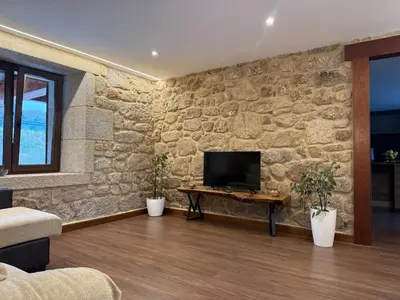a wooden cabinet against a stone wall at Casa con barbacoa · Casa Amelia by Easy Life Rent in Valga