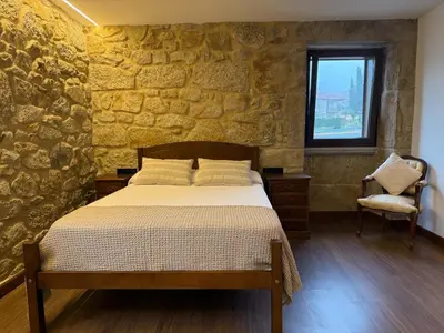 a bedroom with a stone wall and a bed at Casa con barbacoa · Casa Amelia by Easy Life Rent in Valga