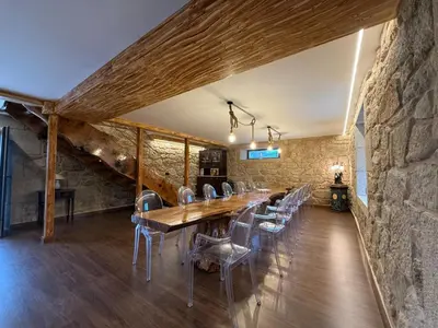 a stone building with benches in front of it at Casa con barbacoa · Casa Amelia by Easy Life Rent in Valga