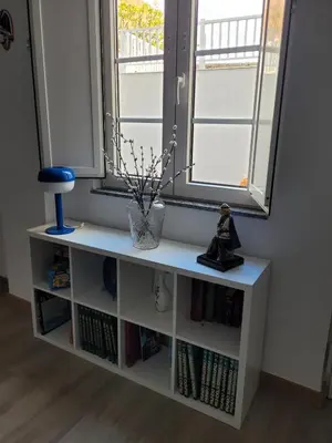 a book shelf in a room with a window at Vaniria 3 Apartamentos Nuevos in Foz