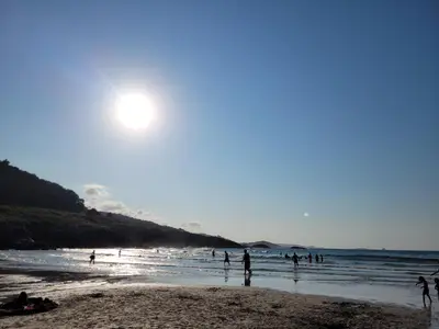 a group of people standing on a beach at Vaniria 3 Apartamentos Nuevos in Foz
