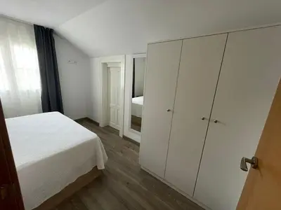 a white bedroom with a bed and a closet at Apartamento Paseo Malécon Planta 3 in Monforte de Lemos