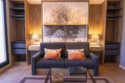 a living room with a blue couch with orange pillows at Caño in Pincelo