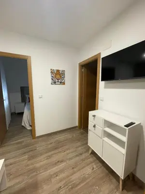 a room with a white dresser and a tv at Apartamento Paseo Malecón Planta 2 in Monforte de Lemos