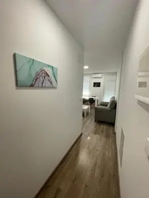 a living room with a couch and a painting on a wall at Apartamento Paseo Malecón Planta 2 in Monforte de Lemos
