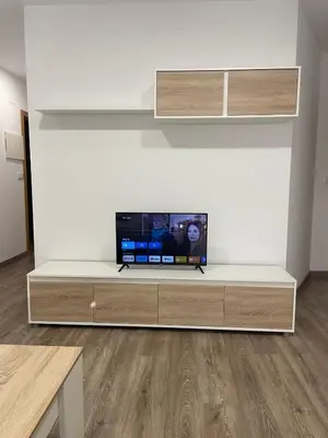 a living room with a tv on a white wall at Apartamento Paseo Malecón Planta 2 in Monforte de Lemos