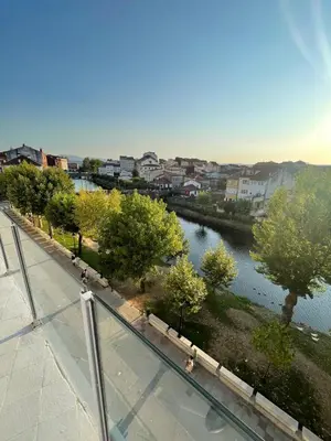 a view of a river with trees and buildings at Apartamento Paseo Malecón Planta 2 in Monforte de Lemos