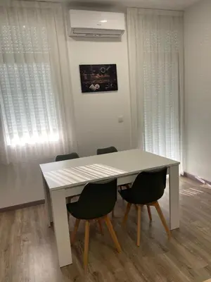 a white table and chairs in a room at Apartamento Paseo Malecón Planta 2 in Monforte de Lemos