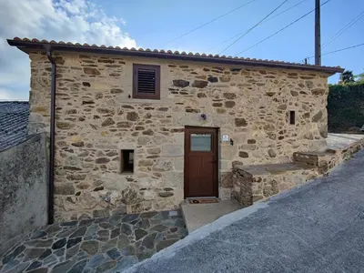 a patio with two chairs and a wall with lights at A Casa de Salvador - retiro rural con alma gallega in Vedra