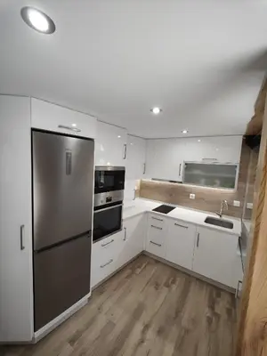 a kitchen with white cabinets and a stainless steel refrigerator at A Casa de Salvador - retiro rural con alma gallega in Vedra