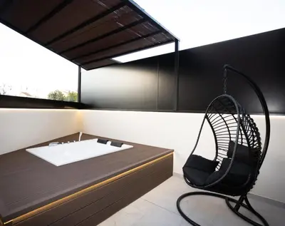 a room with a bed and a chair in it at Dorian Suites in Monforte de Lemos