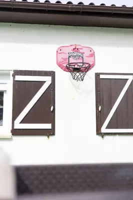 a basketball hoop and a basket on a wall at Villa Las Catedrales - Frente a la playa - Amplio jardín - Piscina in Barreiros
