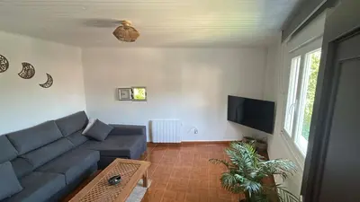 a living room with a couch and a tv at Villa Mallorquina tu zona para desconectar