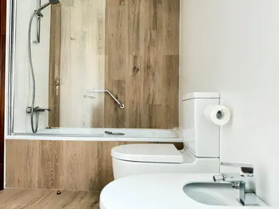 a bathroom with a shower and a toilet and a sink at Casa Aldea de Piñeiro, Turismo Rural Padrón by URent in Padrón