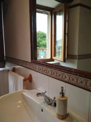 a bathroom with a sink and a mirror at Casa Fonso in Villapedre