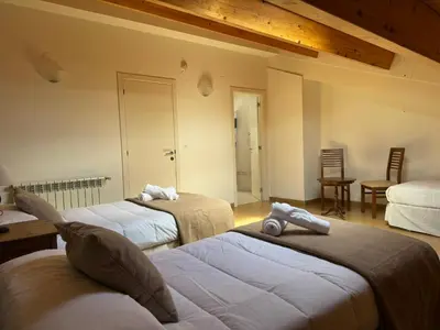 a bedroom with two beds and a table and chairs at Albergue Internacional in Sarria