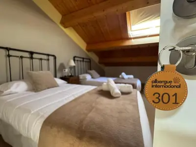 a bedroom with a bed with a price tag on it at Albergue Internacional in Sarria