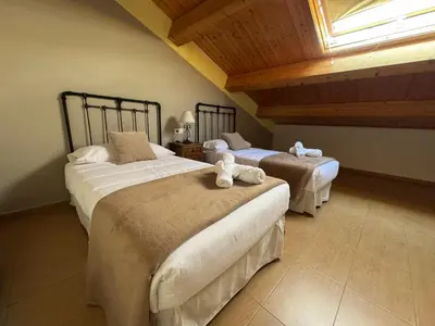 two beds in a room with a attic at Albergue Internacional in Sarria